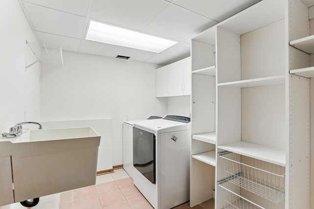 382 Tuttle Dr, Hastings, MN 55033 - laundry room with cabinet space, washing machine and dryer, and light tile patterned floors