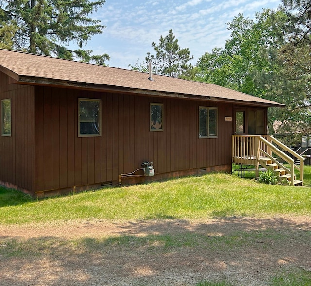 34243 County Highway 46, Park Rapids, MN 56470 - view of side of home featuring roof with shingles, crawl space, and a lawn