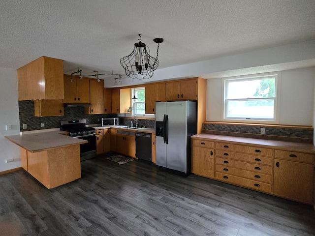 27891 Jerboa Ln, Cold Spring, MN 56320 - kitchen featuring appliances with stainless steel finishes, a peninsula, a textured ceiling, dark wood finished floors, and tasteful backsplash