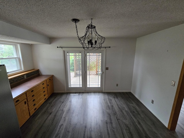 27891 Jerboa Ln, Cold Spring, MN 56320 - unfurnished dining area featuring a chandelier, dark wood finished floors, and a textured ceiling