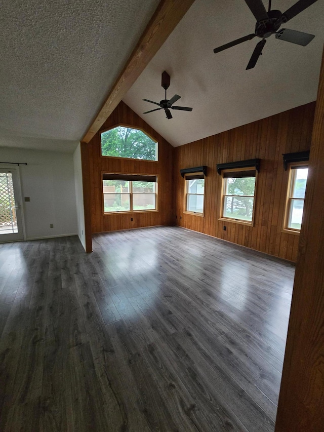 27891 Jerboa Ln, Cold Spring, MN 56320 - unfurnished living room featuring a ceiling fan, wood finished floors, beam ceiling, wooden walls, and a textured ceiling