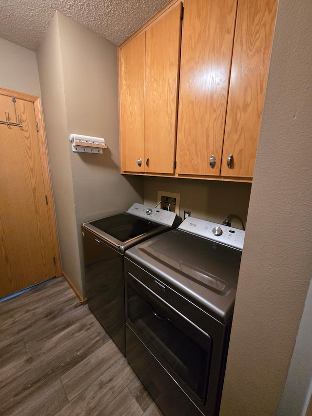 27891 Jerboa Ln, Cold Spring, MN 56320 - laundry room with cabinet space, independent washer and dryer, a textured ceiling, and dark wood-type flooring