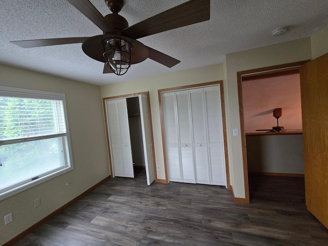 27891 Jerboa Ln, Cold Spring, MN 56320 - unfurnished bedroom featuring a textured ceiling, multiple closets, wood finished floors, and a ceiling fan