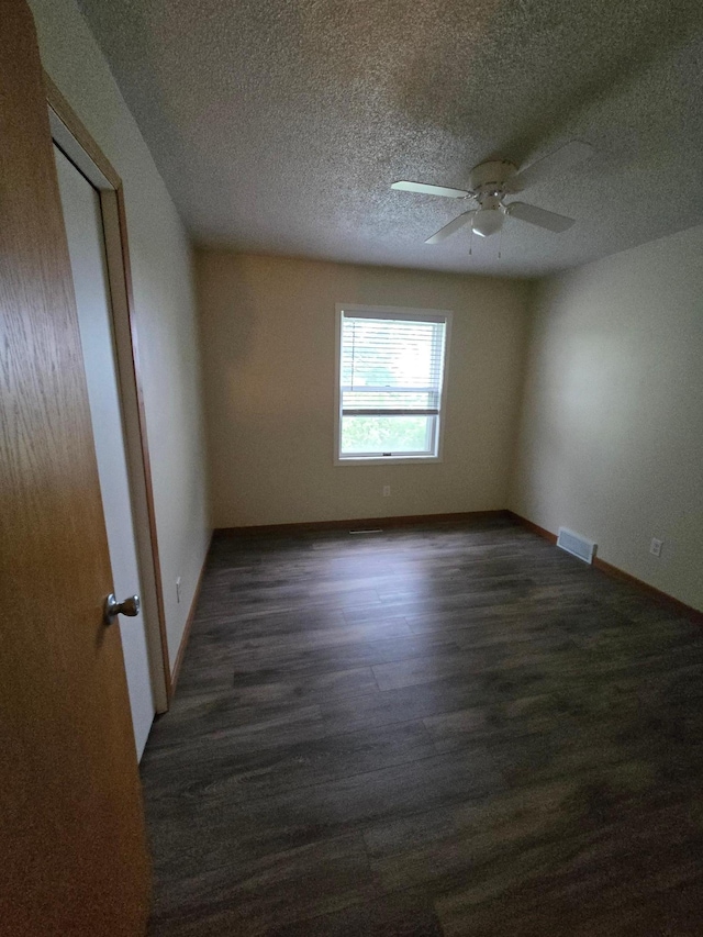 27891 Jerboa Ln, Cold Spring, MN 56320 - empty room featuring dark wood-style flooring, a ceiling fan, and a textured ceiling