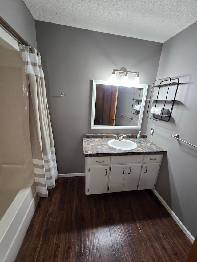 27891 Jerboa Ln, Cold Spring, MN 56320 - full bath featuring wood finished floors, vanity, a textured ceiling, and shower / tub combo