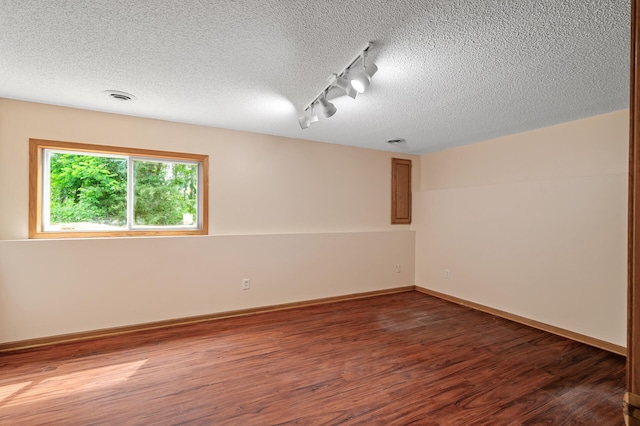 17121 Variolite St NW, Ramsey, MN 55303 - unfurnished room with track lighting, a textured ceiling, and wood finished floors