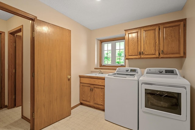 17121 Variolite St NW, Ramsey, MN 55303 - washroom with washer and dryer, cabinet space, light floors, and a textured ceiling