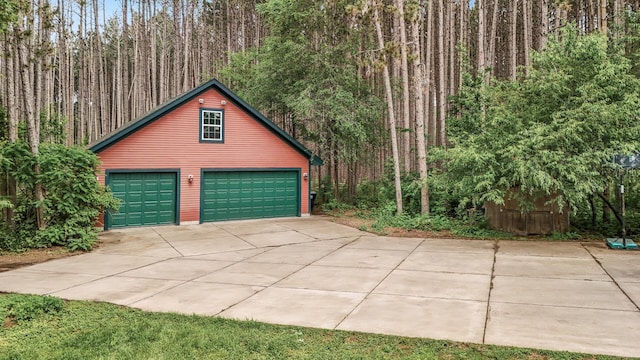 17121 Variolite St NW, Ramsey, MN 55303 - garage with a view of trees, a garage, and driveway