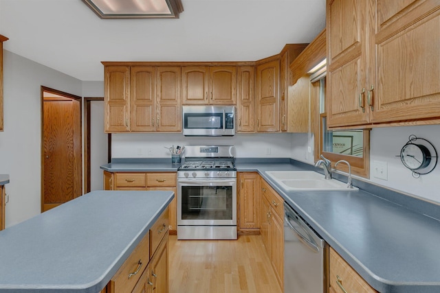 808 17th St SW, Willmar, MN 56201 - kitchen with appliances with stainless steel finishes, light wood-type flooring, and a center island