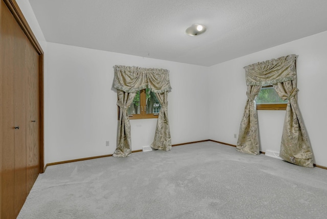 808 17th St SW, Willmar, MN 56201 - unfurnished bedroom with carpet flooring, a closet, and a textured ceiling