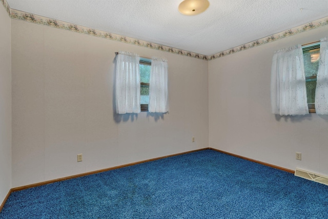 808 17th St SW, Willmar, MN 56201 - carpeted spare room featuring a textured ceiling and baseboards