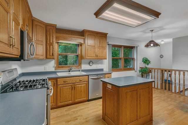 808 17th St SW, Willmar, MN 56201 - kitchen with appliances with stainless steel finishes, light wood finished floors, plenty of natural light, and brown cabinets
