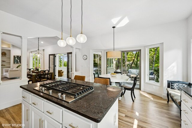 820 Vineland Ct, Chanhassen, MN 55317 - kitchen with stainless steel gas stovetop, light wood-style floors, white cabinetry, a center island, and pendant lighting