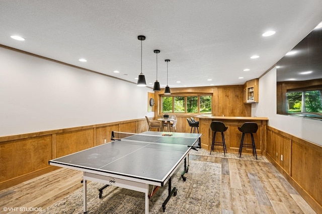 820 Vineland Ct, Chanhassen, MN 55317 - rec room featuring wainscoting, light wood-style floors, recessed lighting, bar area, and wooden walls