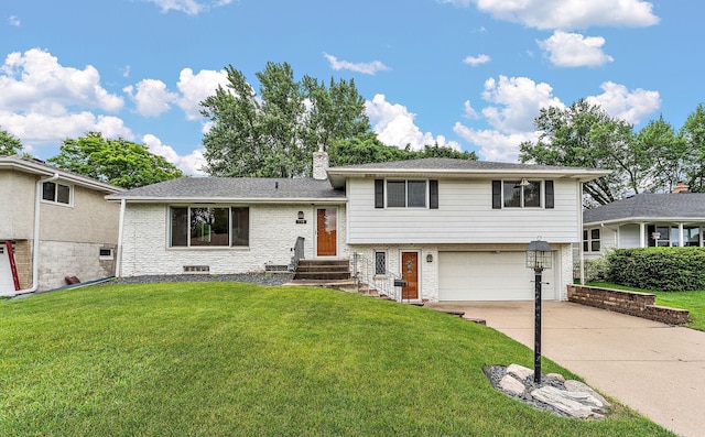 354 Edith Dr W, Saint Paul, MN 55118 - tri-level home featuring an attached garage, concrete driveway, a front yard, brick siding, and entry steps