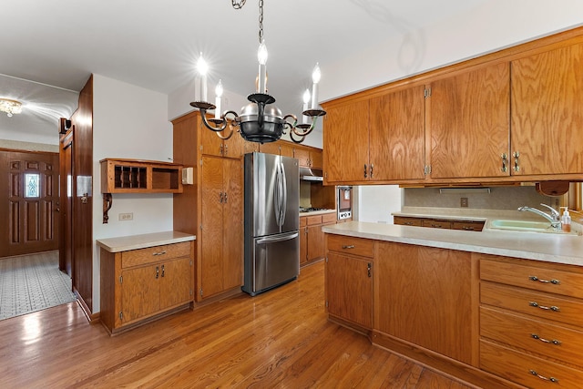 354 Edith Dr W, Saint Paul, MN 55118 - kitchen with stainless steel appliances, open shelves, brown cabinetry, a chandelier, and light wood finished floors