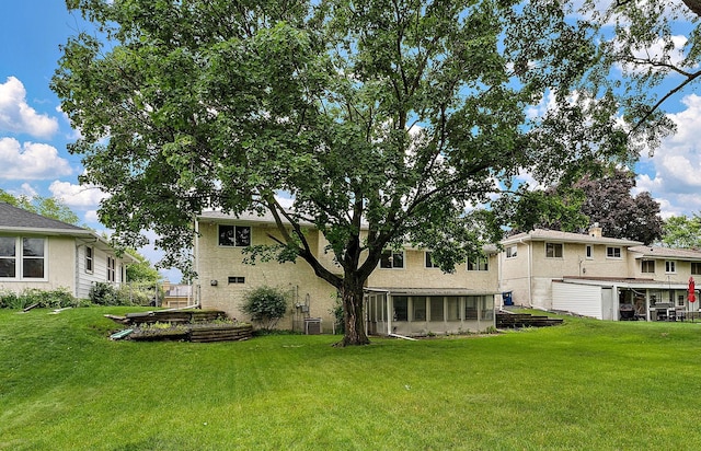 354 Edith Dr W, Saint Paul, MN 55118 - rear view of property with a yard and a sunroom
