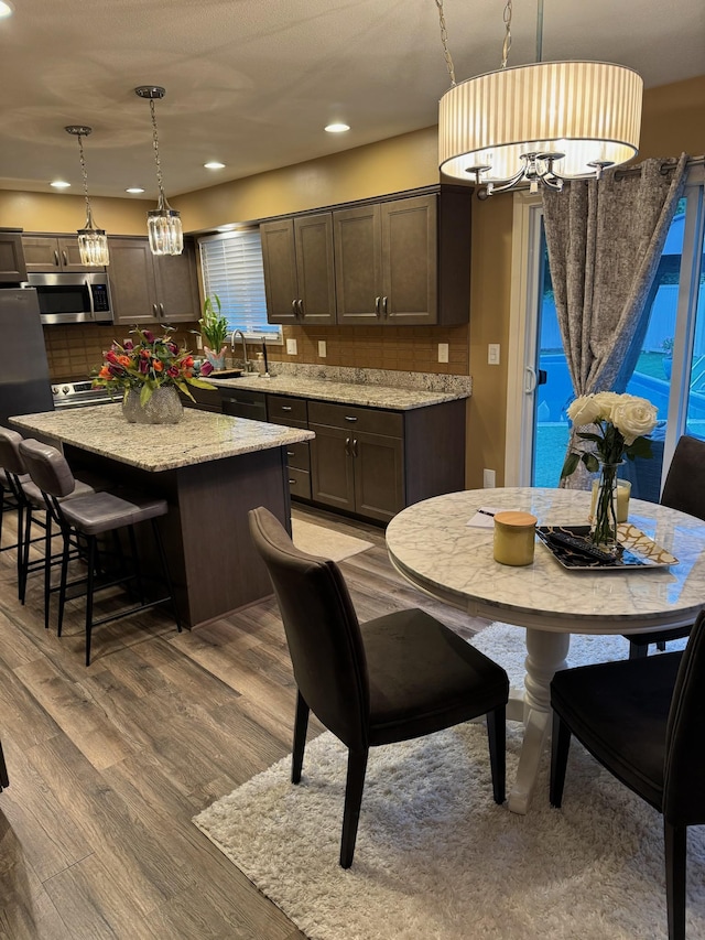 1439 7th St SW, New Brighton, MN 55112 - dining room featuring wood finished floors, recessed lighting, and a chandelier