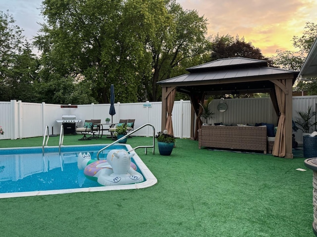 1439 7th St SW, New Brighton, MN 55112 - pool at dusk with an outdoor hangout area, a gazebo, and a fenced backyard