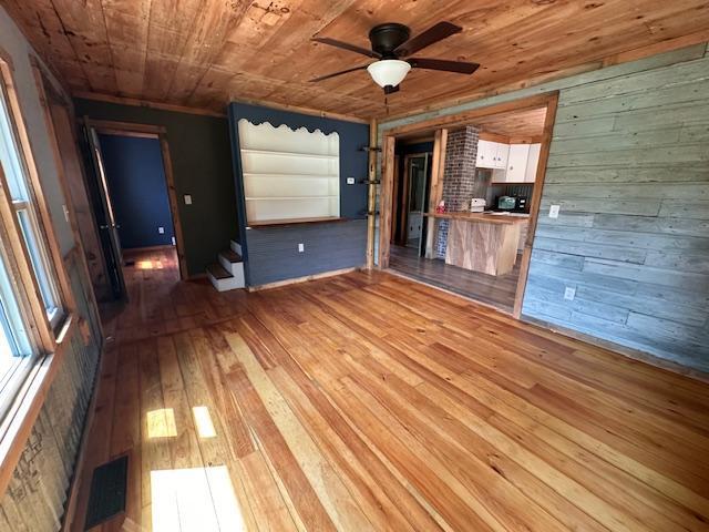 4623 Salo Rd, Waasa Twp, MN 55732 - unfurnished living room with wood walls, light wood-style floors, ceiling fan, and wooden ceiling