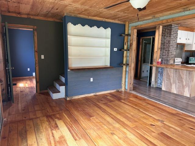 4623 Salo Rd, Waasa Twp, MN 55732 - unfurnished living room with wood-type flooring, wooden ceiling, stairs, and a ceiling fan