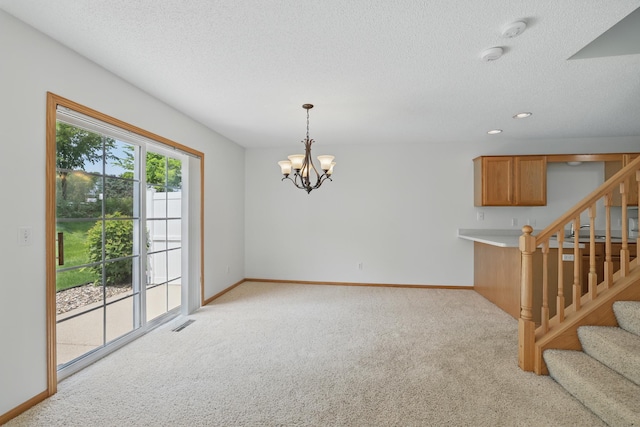 8741 Quarry Ridge Ln Unit H, Woodbury, MN 55125 - unfurnished living room featuring light colored carpet, stairway, a chandelier, a textured ceiling, and recessed lighting