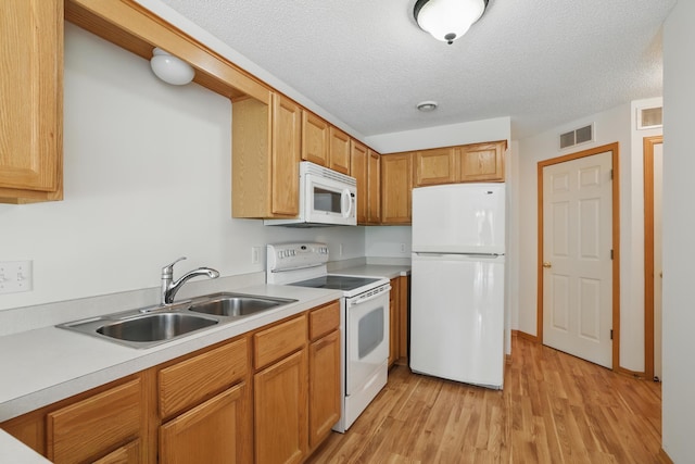 8741 Quarry Ridge Ln Unit H, Woodbury, MN 55125 - kitchen with white appliances, light wood-type flooring, light countertops, and a textured ceiling