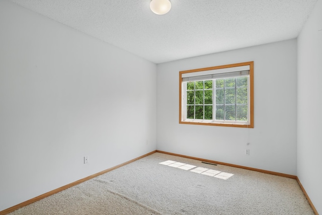 8741 Quarry Ridge Ln Unit H, Woodbury, MN 55125 - carpeted spare room featuring baseboards and a textured ceiling