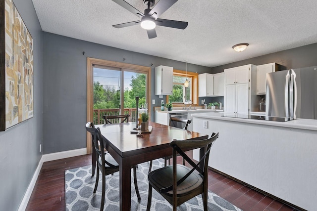 9700 265th St, Elko New Market, MN 55020 - dining area featuring dark wood finished floors, a textured ceiling, and ceiling fan