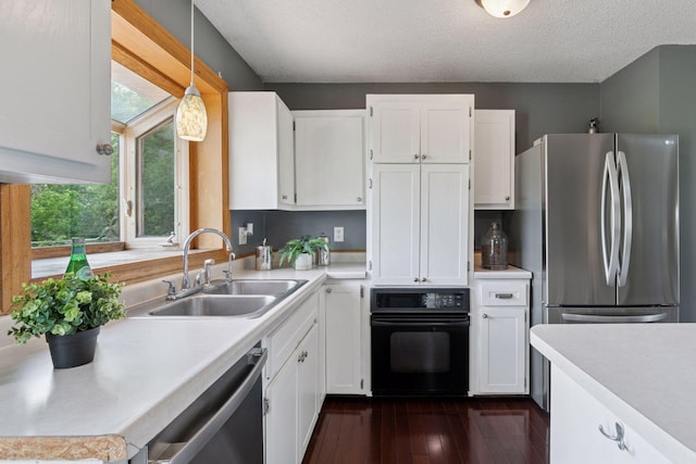9700 265th St, Elko New Market, MN 55020 - kitchen featuring stainless steel appliances, light countertops, white cabinets, dark wood finished floors, and pendant lighting