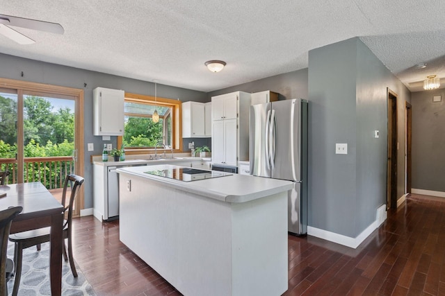 9700 265th St, Elko New Market, MN 55020 - kitchen featuring stainless steel appliances, dark wood-type flooring, light countertops, white cabinetry, and a center island