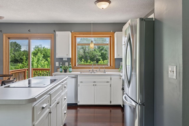 9700 265th St, Elko New Market, MN 55020 - kitchen with appliances with stainless steel finishes, a textured ceiling, light countertops, white cabinets, and dark wood-style flooring