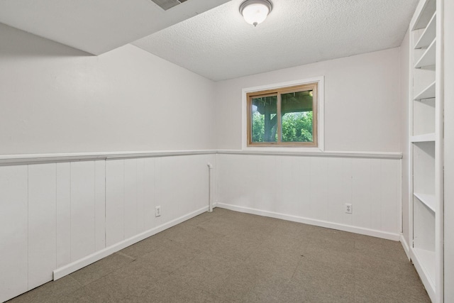 9700 265th St, Elko New Market, MN 55020 - carpeted empty room featuring a wainscoted wall and a textured ceiling