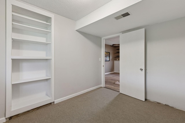 9700 265th St, Elko New Market, MN 55020 - unfurnished bedroom featuring carpet floors and a textured ceiling