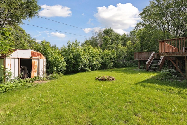 9700 265th St, Elko New Market, MN 55020 - view of grassy yard with a storage unit, stairs, and a deck