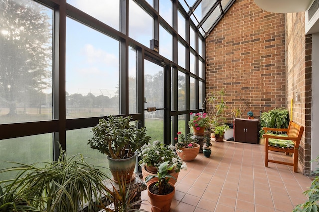 1181 Edgcumbe Rd Unit 501, Saint Paul, MN 55105 - sunroom / solarium with a towering ceiling, tile patterned flooring, brick wall, and a wall of windows