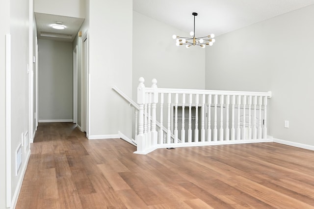 1527 Harvest Ln, Shakopee, MN 55379 - corridor featuring an upstairs landing, wood finished floors, and a chandelier