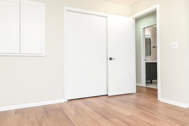 1527 Harvest Ln, Shakopee, MN 55379 - unfurnished bedroom featuring light wood-style flooring and a closet