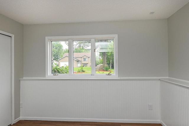 1527 Harvest Ln, Shakopee, MN 55379 - empty room featuring a wainscoted wall and wood finished floors