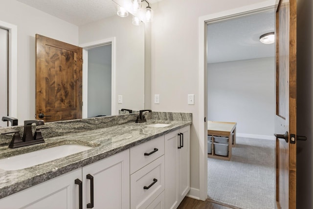14217 Packard St NE, Ham Lake, MN 55304 - bathroom featuring double vanity and baseboards