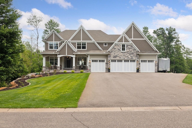 14217 Packard St NE, Ham Lake, MN 55304 - craftsman inspired home with stone siding, driveway, a front lawn, covered porch, and an attached garage