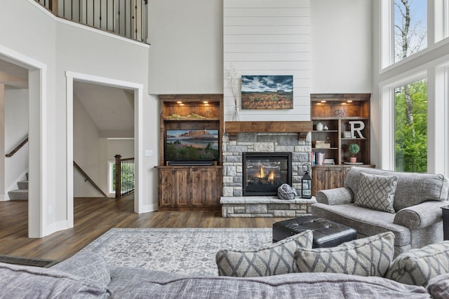 14217 Packard St NE, Ham Lake, MN 55304 - living area featuring a high ceiling, wood finished floors, a fireplace, and stairs