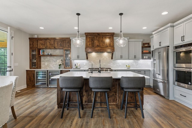 14217 Packard St NE, Ham Lake, MN 55304 - kitchen with open shelves, stainless steel appliances, beverage cooler, custom exhaust hood, and recessed lighting