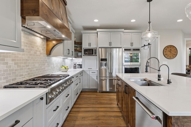 14217 Packard St NE, Ham Lake, MN 55304 - kitchen featuring stainless steel appliances, wall chimney exhaust hood, light countertops, backsplash, and dark wood-type flooring