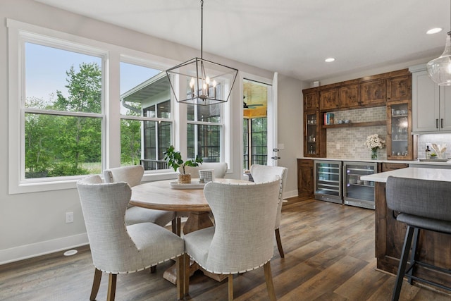 14217 Packard St NE, Ham Lake, MN 55304 - dining area featuring beverage cooler, dark wood-style floors, recessed lighting, a chandelier, and a bar