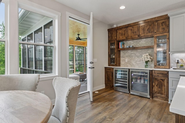 14217 Packard St NE, Ham Lake, MN 55304 - indoor dry bar featuring beverage cooler, decorative backsplash, dark wood finished floors, and recessed lighting