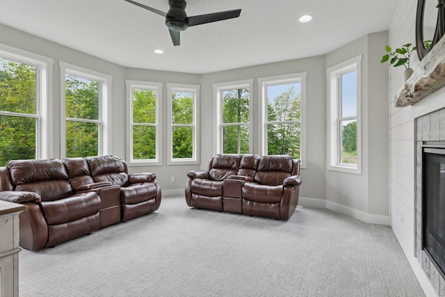 14217 Packard St NE, Ham Lake, MN 55304 - living area featuring a tile fireplace, ceiling fan, light colored carpet, and recessed lighting