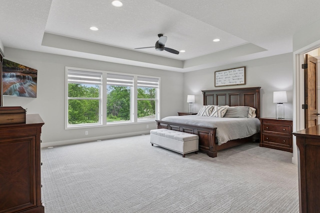 14217 Packard St NE, Ham Lake, MN 55304 - bedroom with light colored carpet, a tray ceiling, recessed lighting, and ceiling fan