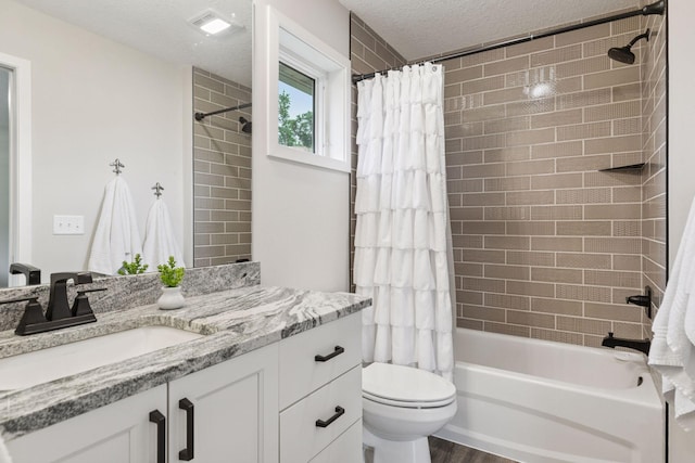 14217 Packard St NE, Ham Lake, MN 55304 - bathroom featuring vanity, shower / bath combo, and a textured ceiling