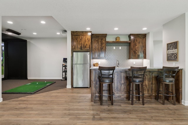 14217 Packard St NE, Ham Lake, MN 55304 - kitchen with freestanding refrigerator, light wood-style flooring, light countertops, dark brown cabinetry, and recessed lighting